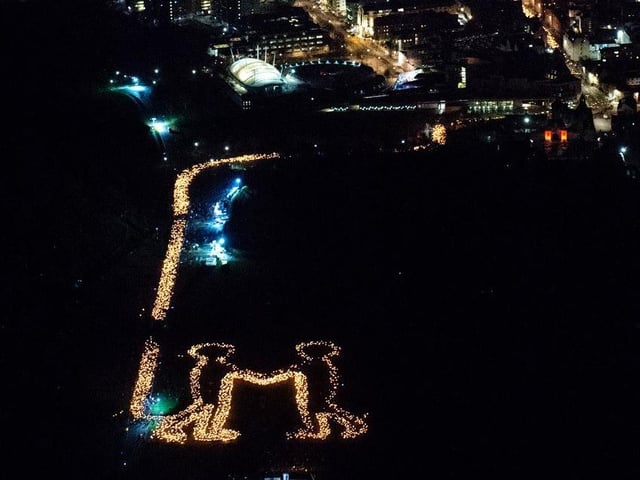 The scene in Holyrood Park was captured from a helicopter overhead creating an image to be shared with the world a message of welcome and friendship from Scotland. Pic: Edinburgh's Hogmanay