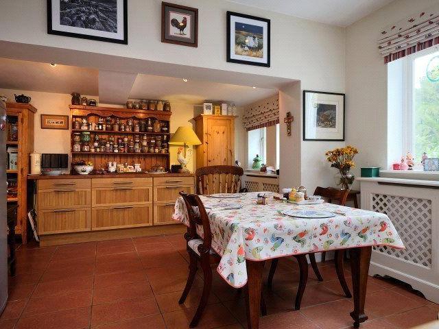 The kitchen also has space for dining, as well as a range of timber wall and floor units providing good storage space.